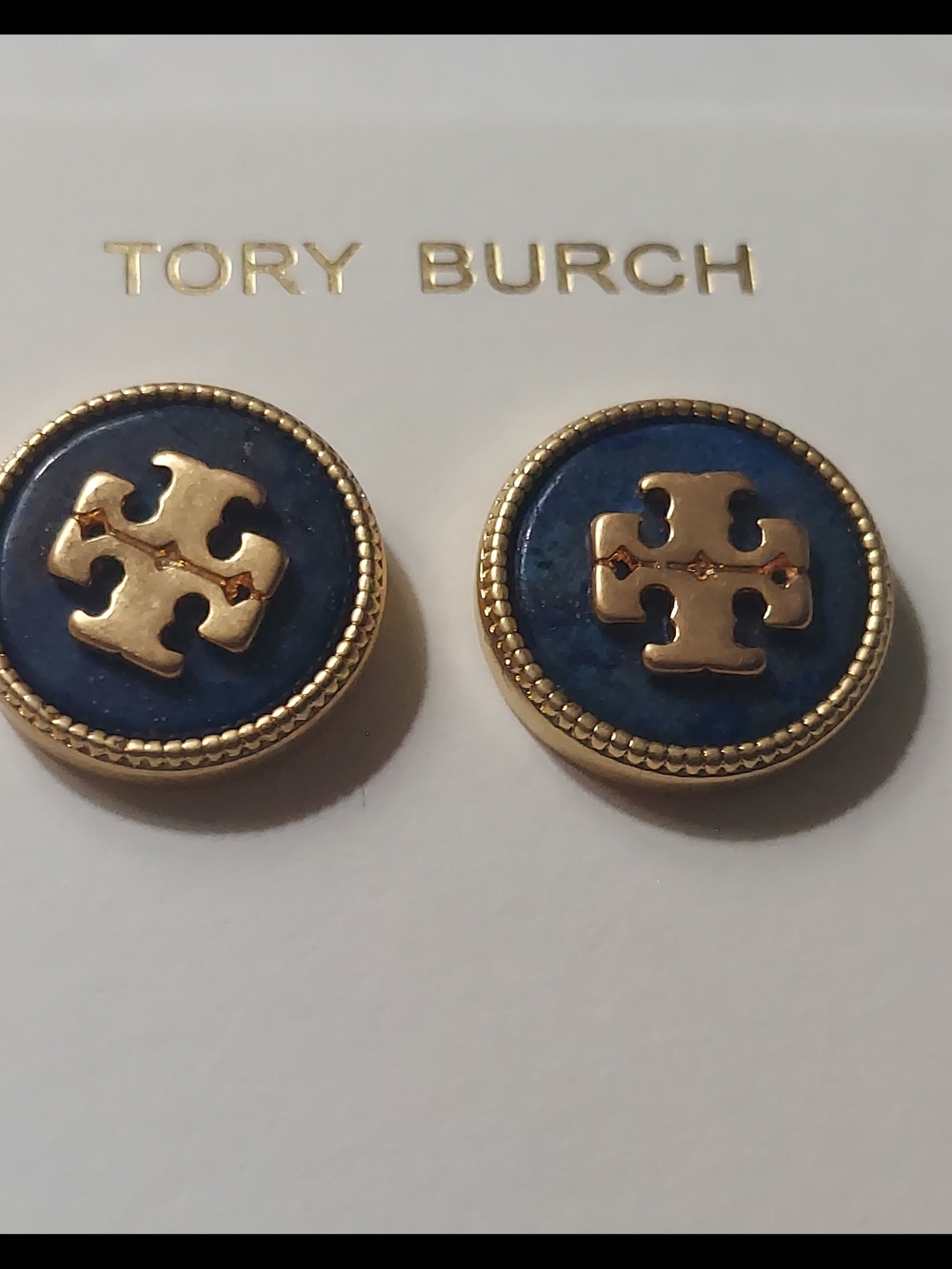 Tory Burch Kira semiprecious stud earrings feature a navy blue lapis stone.
